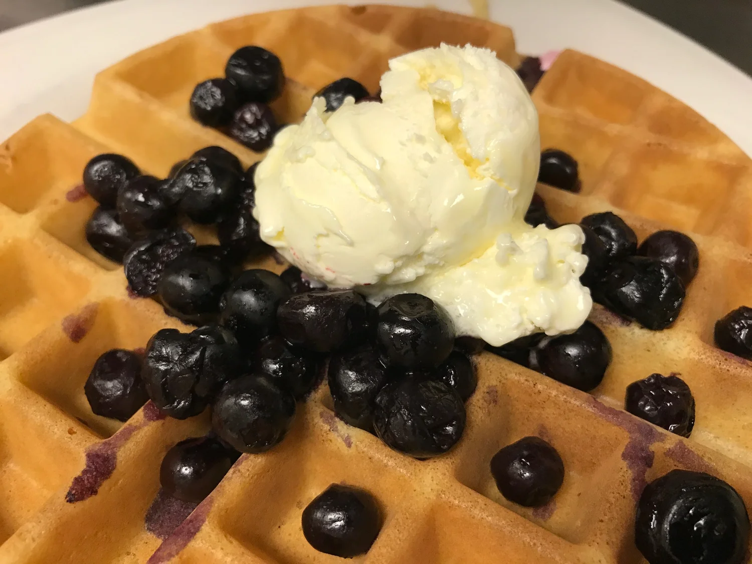 Golden Belgian waffle topped with blueberries