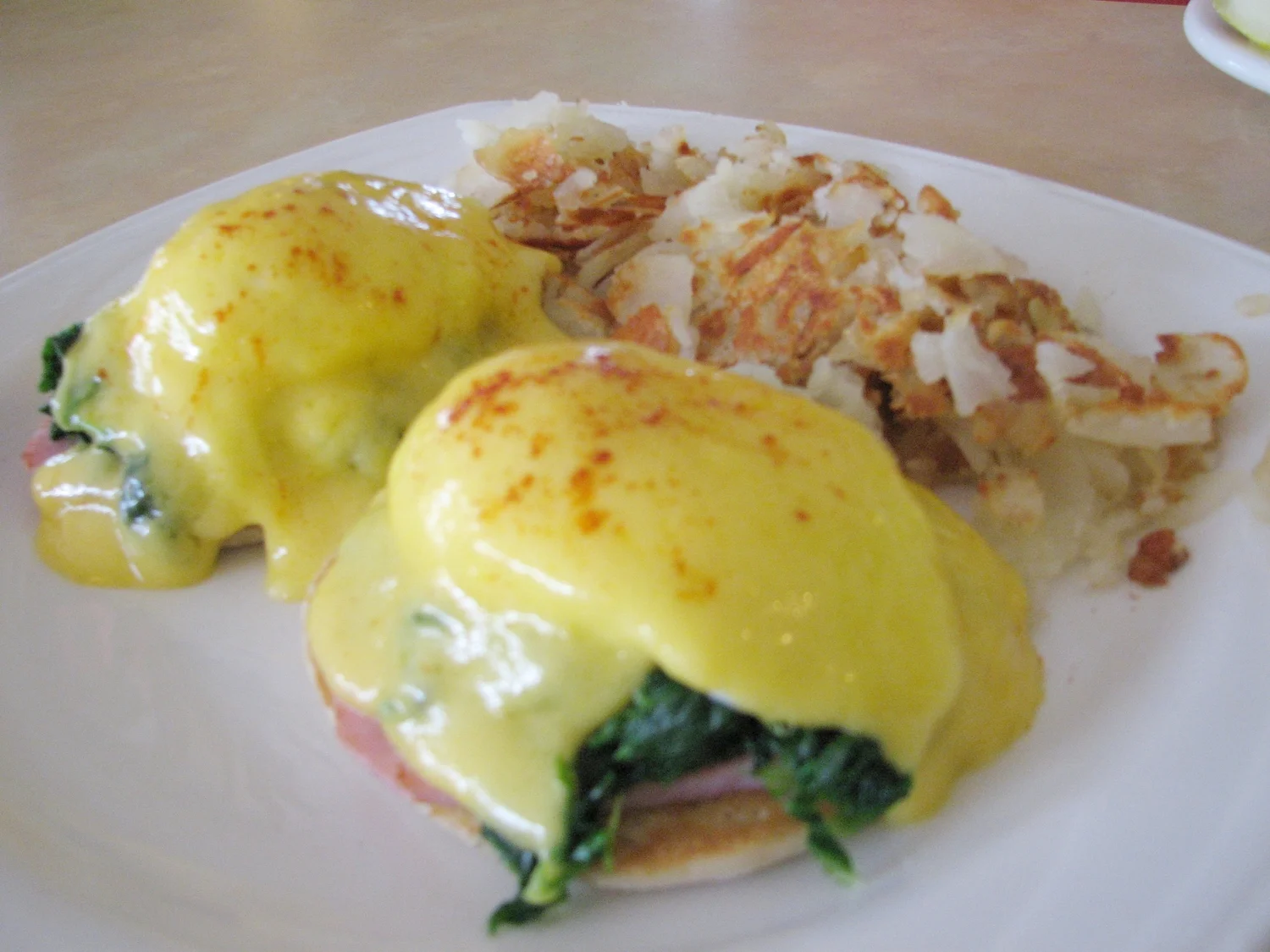 Classic eggs Benedict with hollandaise on an English muffin